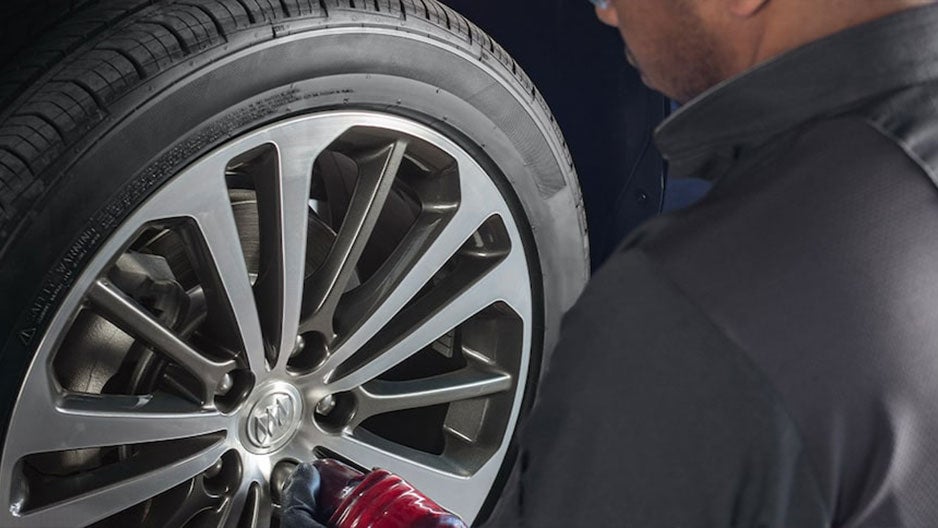 Checking the car's wheel - Finnegan Buick GMC in Rosenberg TX