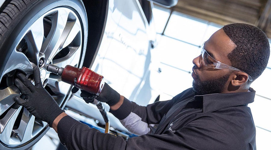 Service technician working on a vehicle - Finnegan Buick GMC in Rosenberg TX