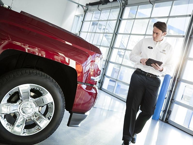 Technicians inspecting vehicle